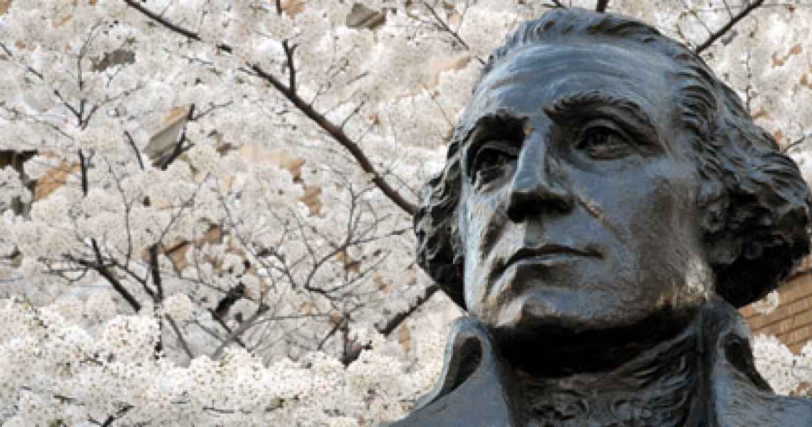 Bust of George Washington in front of cherry blossoms