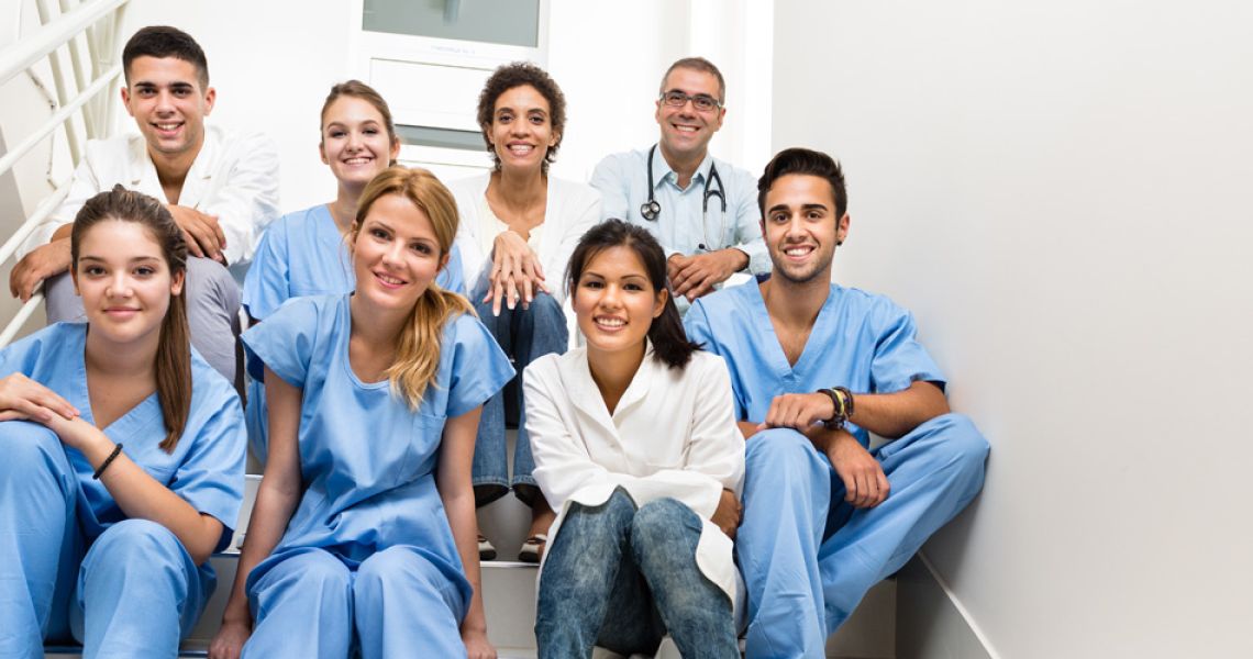 a group of medical students sitting on stairs